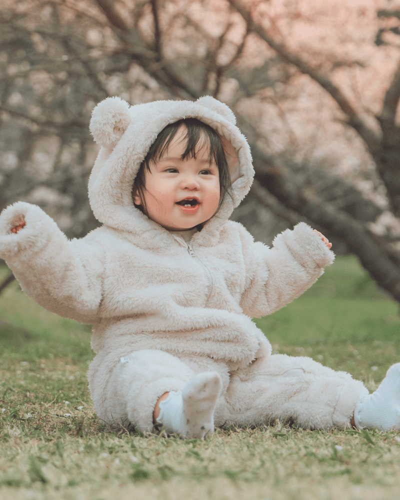 Newborn baby wrapped in a pink blanket on a soft white surface