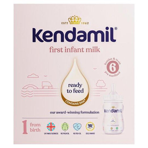 Kendamil first infant milk packaging on a light pink background